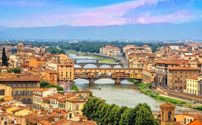 an airshot of florence and the Ponte Vecchio stone bridge over the Arno river