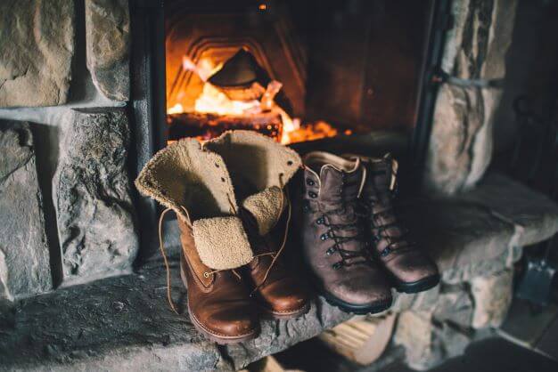 warm winter boots in front of a fire