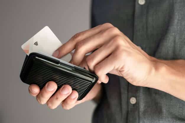 A man puts cards into a RFID wallet