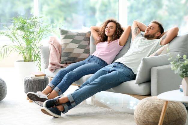 couple relaxing on comfy sofa