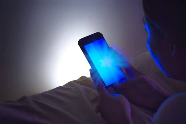 Blue light emanating from mobile telephone