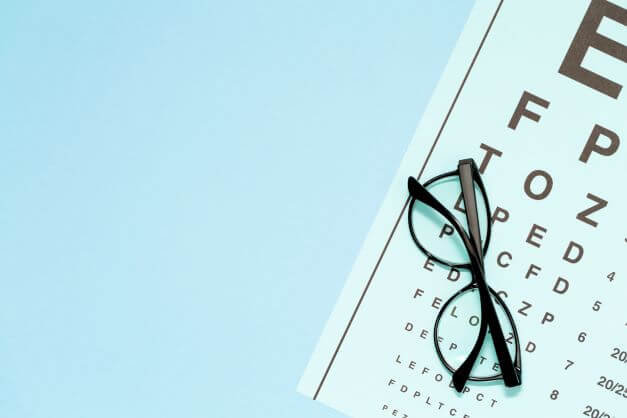 An eye chart and reading glasses
