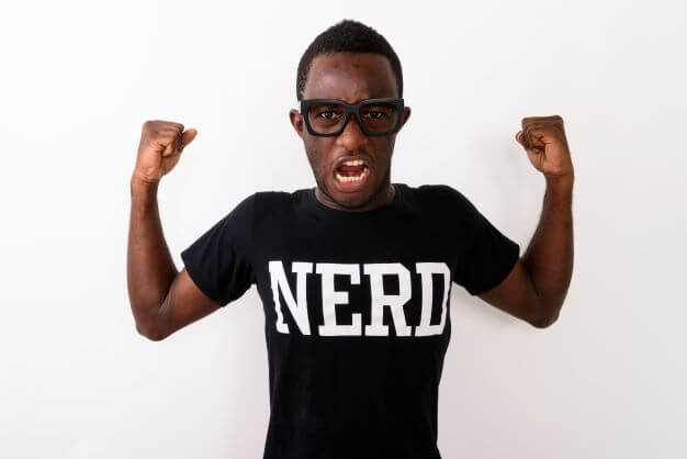 A geeky guy wearing a t-shirt with NERD written on