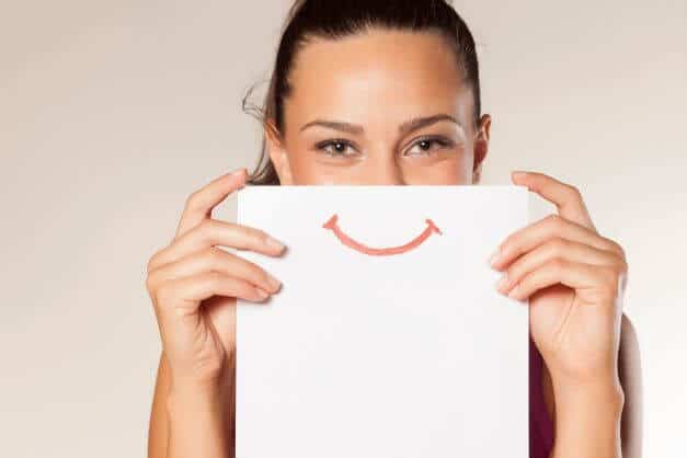 Lady holding up a paper with a smile on