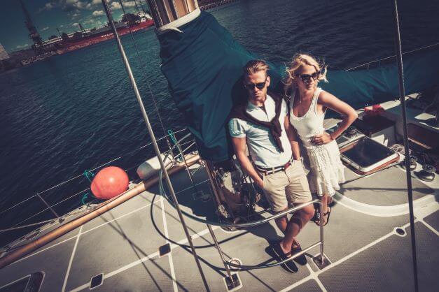 Stylish wealthy couple on a yacht