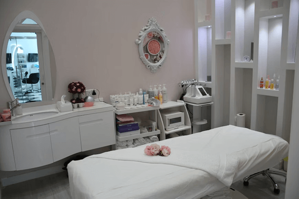 A massage table in a bright white room