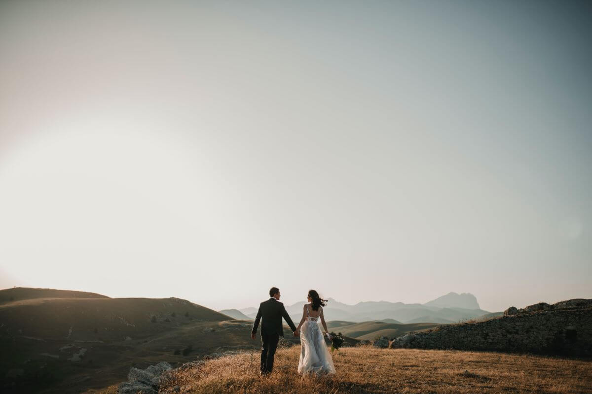 bride and groom on a hill