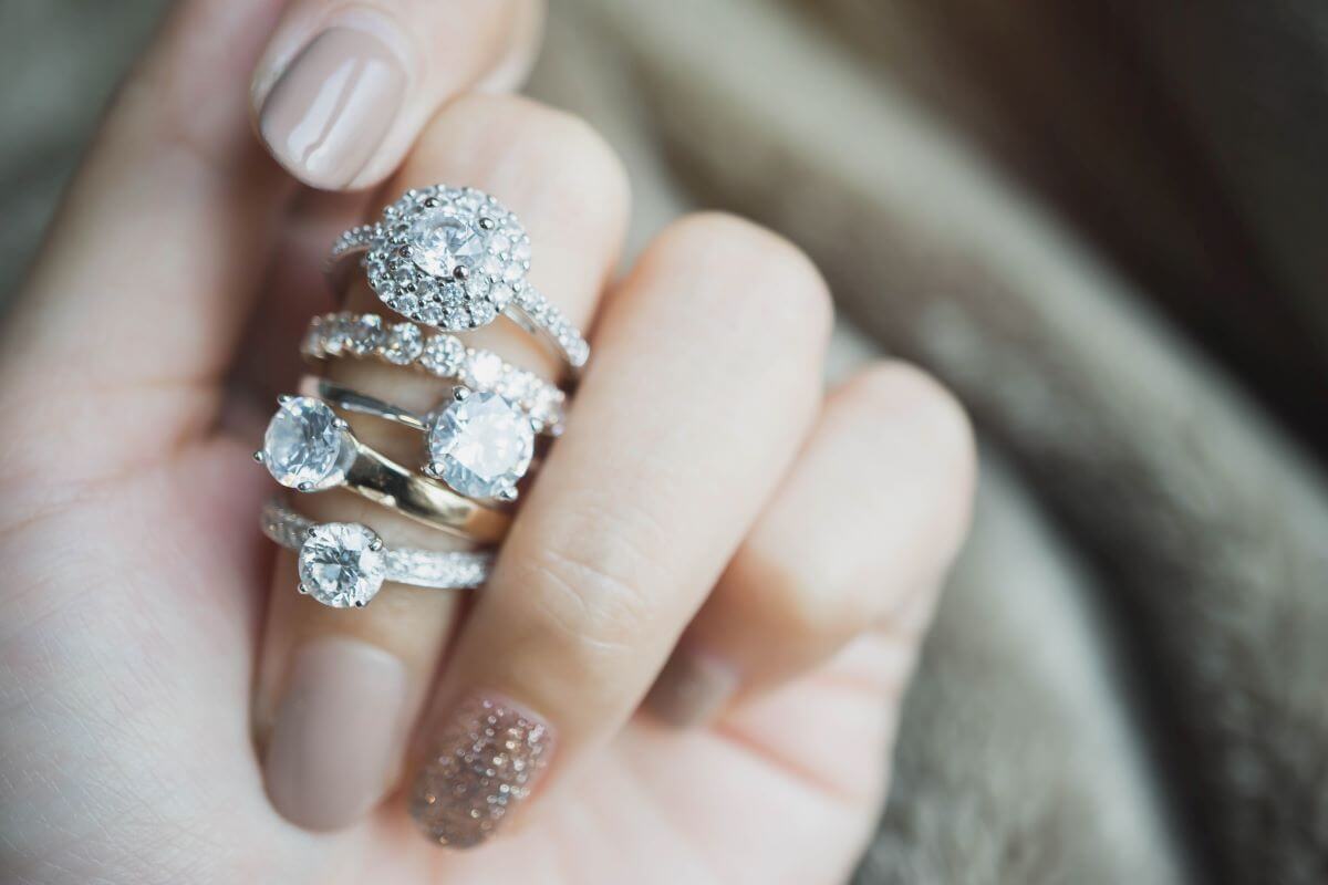 a womans hand with diamond engagement rings