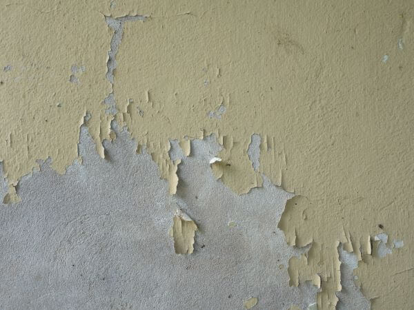 Old flaky paint on a plaster wall
