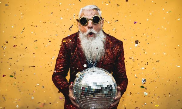 An old raver holding a glitterball