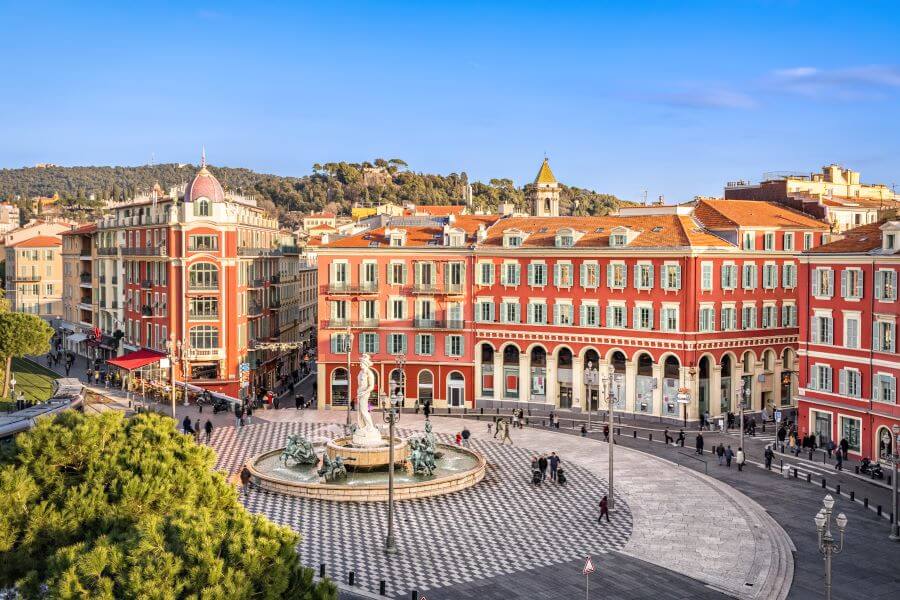 Massena square with red buildings and fountain in Nice France