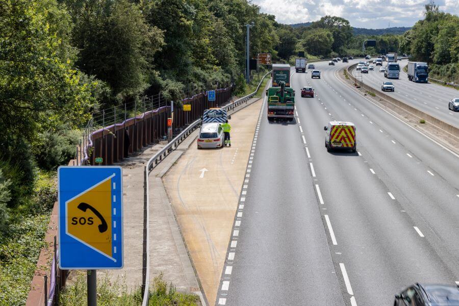 rescue worker collects broken down car on motorway